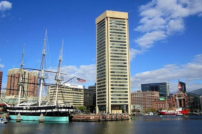 The sloop-of-war USS Constellation moored in the Inner Harbor below the World Trade Center tower